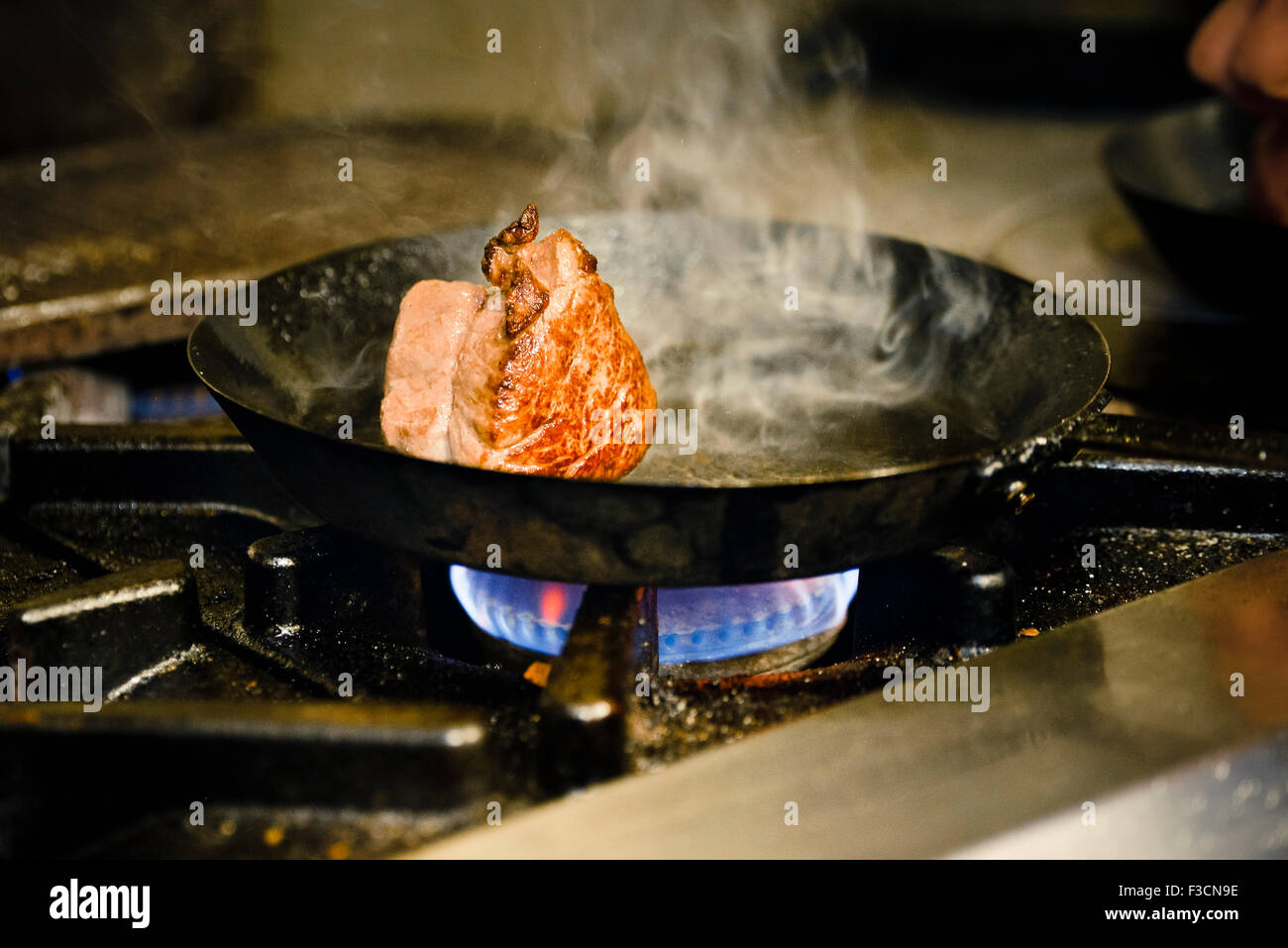 Meat cut browning in pan Stock Photo Alamy