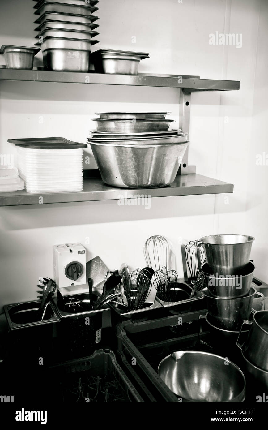 Corner of commercial kitchen with containers and utensils Stock Photo