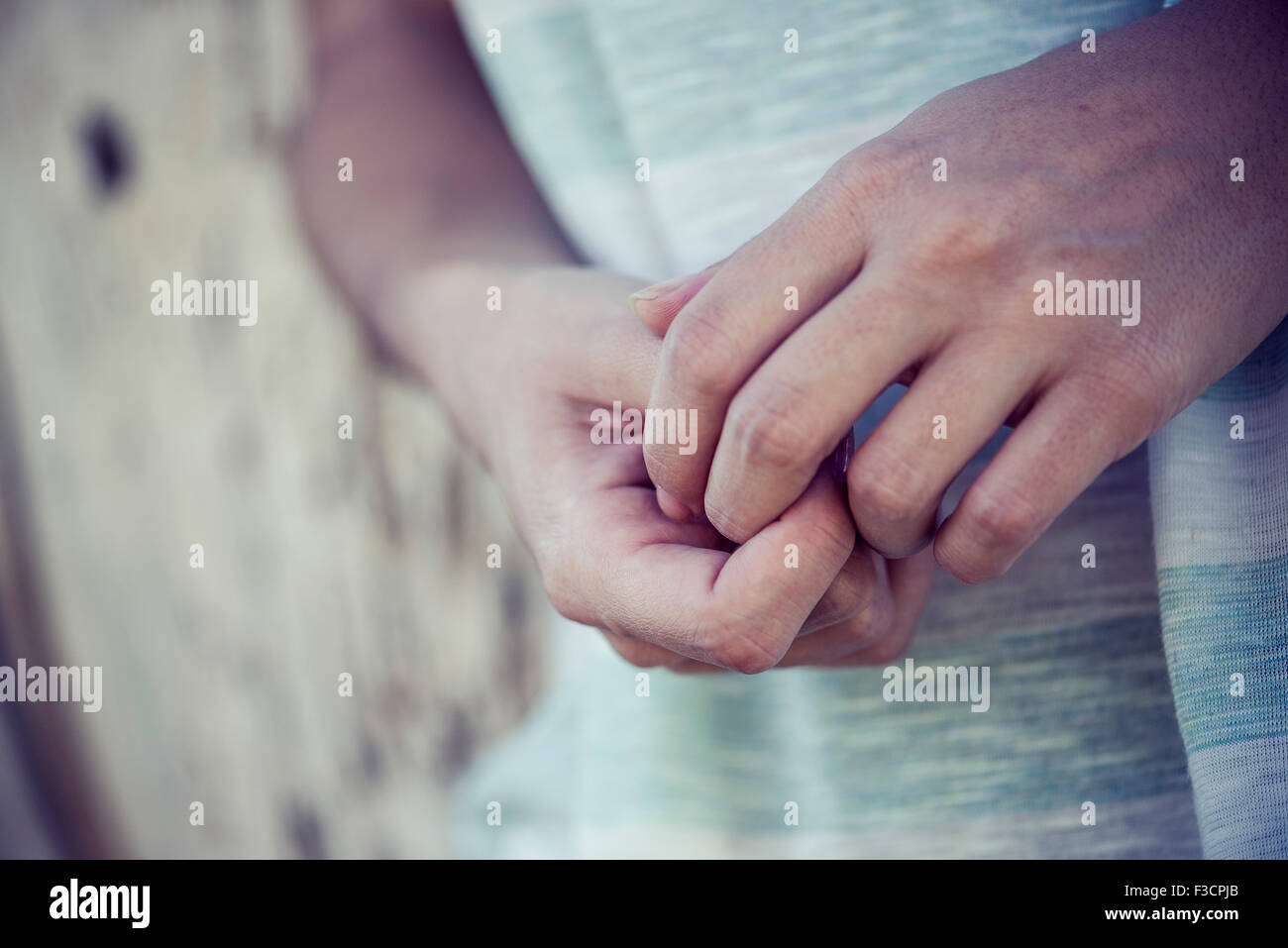 Woman's clasped hands, close-up Stock Photo