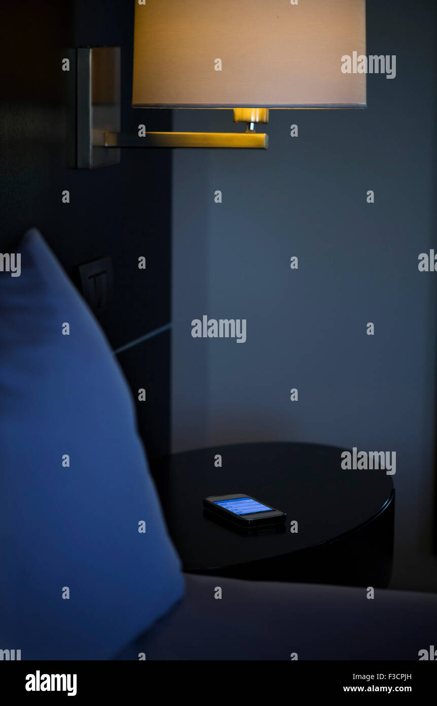 Wall light next to bed in hotel room Stock Photo Alamy