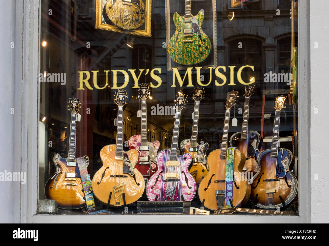 D'Angelico hollow body jazz guitars displayed in the window of Rudy's Music in Soho in New York City Stock Photo
