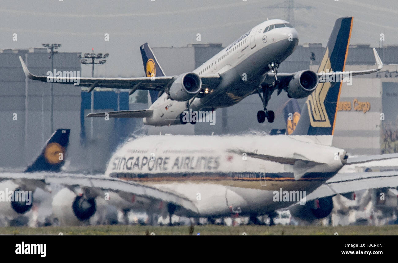 A Lufthansa passenger jet takes off in front of a taxiing Singapore Airlines Airbus A 380, in Frankfurt am Main, Germany, 5 October 2015. Critics expect an increase in noise pollution when the new terminal 3 opens in 2022. PHOTO: BORIS ROESSLER/DPA Stock Photo