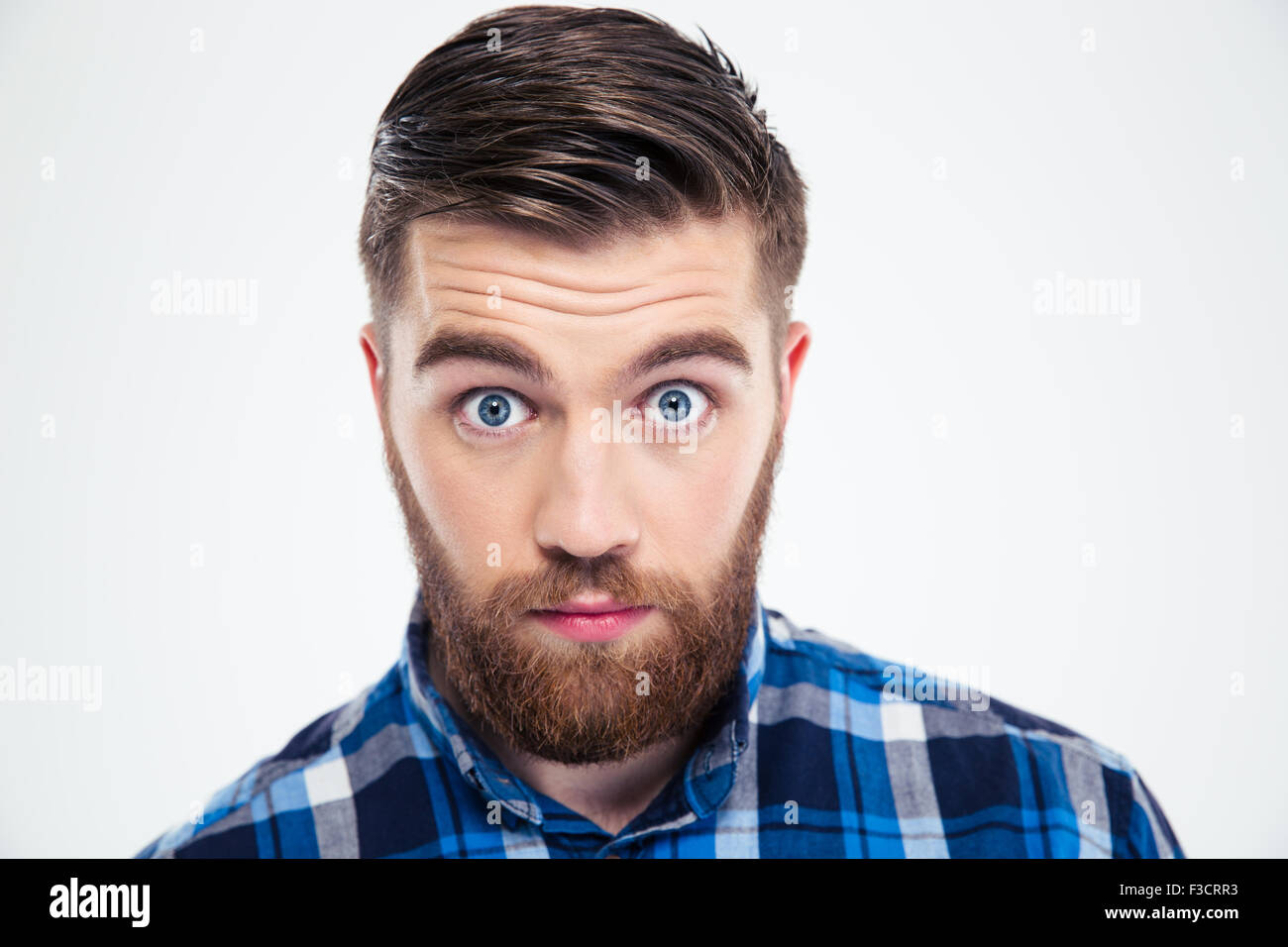 Portrait of a man with big eyes looking at camera isolated on a white background Stock Photo