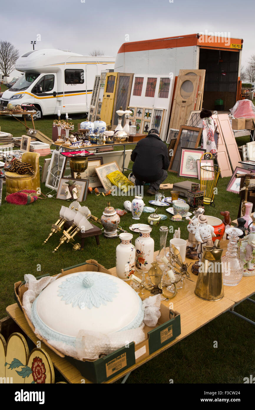 UK, England, Lincolnshire, Lincoln, Antiques Fair, customer browsing bric a brac on tables and ground Stock Photo