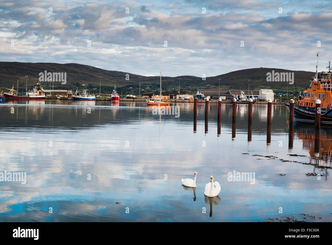 The harbour at Castletownbere, a fishing town on the Beara peninsula, west Cork, Ireland, with Bere Island in the background across Bantry Bay Stock Photo