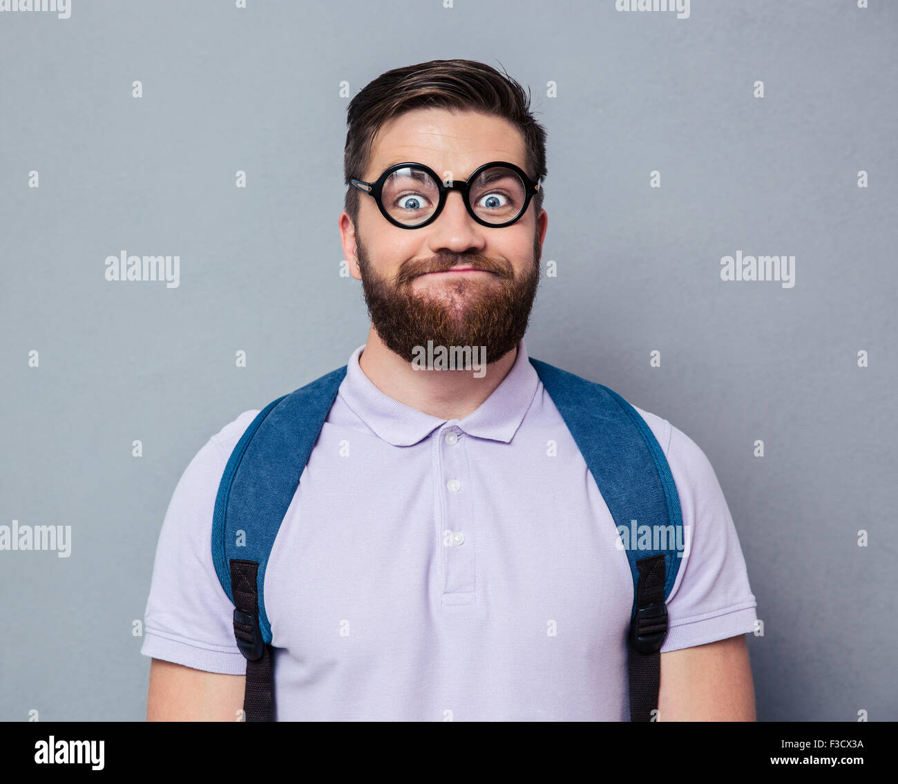 Portrait of a male nerd with funny face over gray background Stock Photo