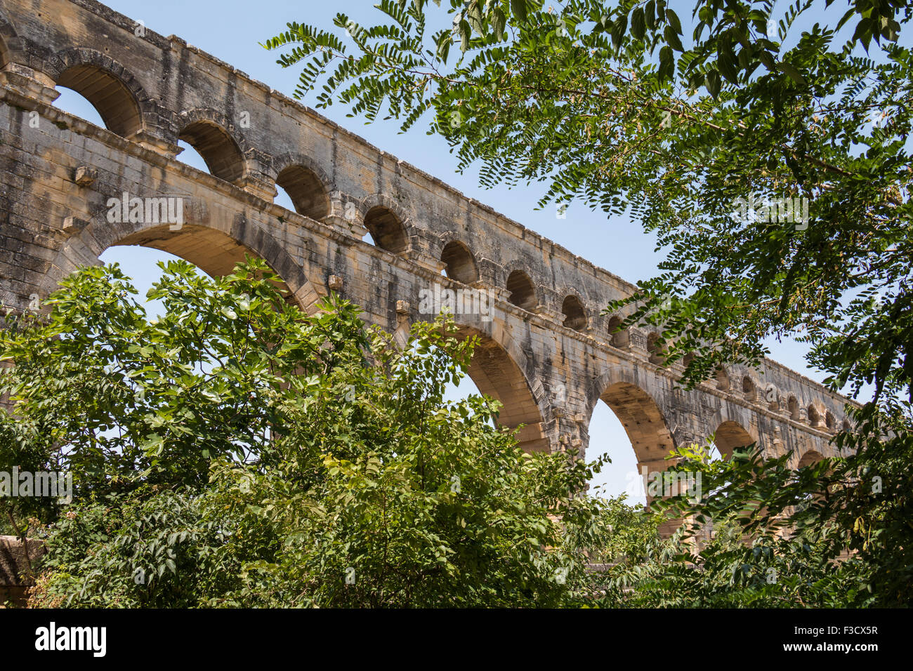 Pont du Gard, ancient Roman aqueduct in France - detail in between trees Stock Photo