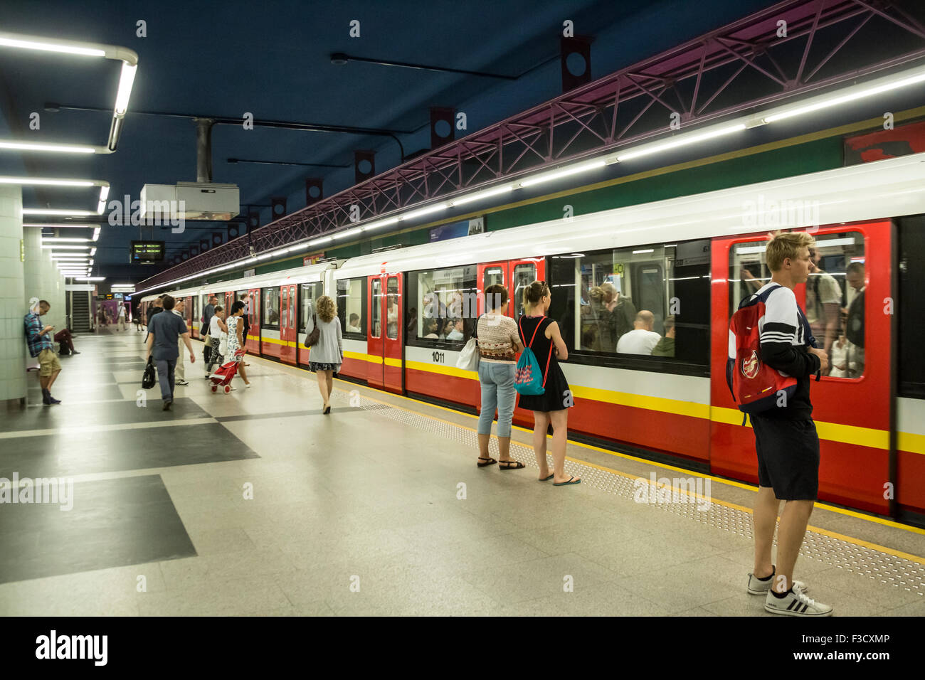 Poland Warsaw Metro station platform with passengers and arriving train  Stock Photo - Alamy