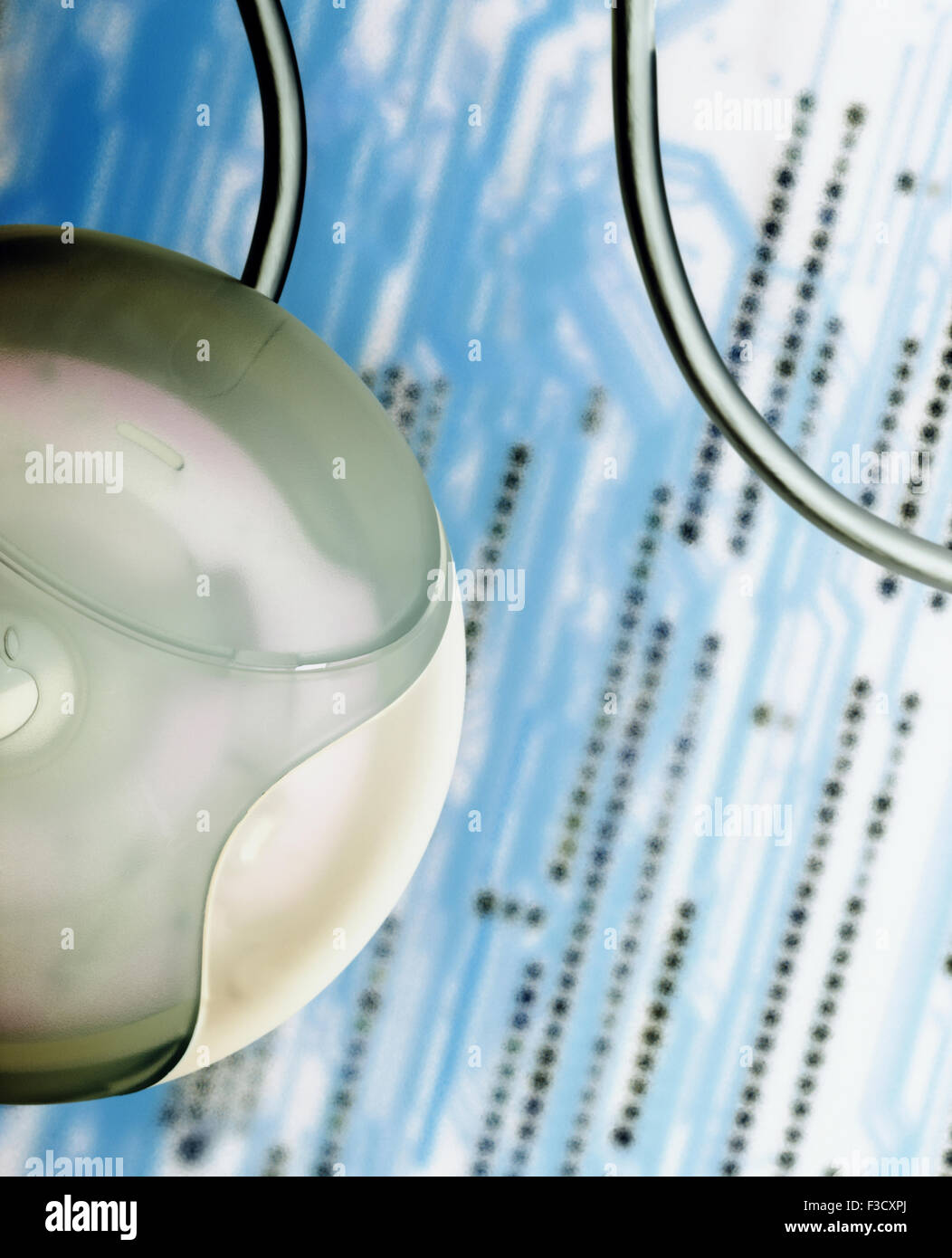 An Apple computer mouse against a background of a mother board. The ...