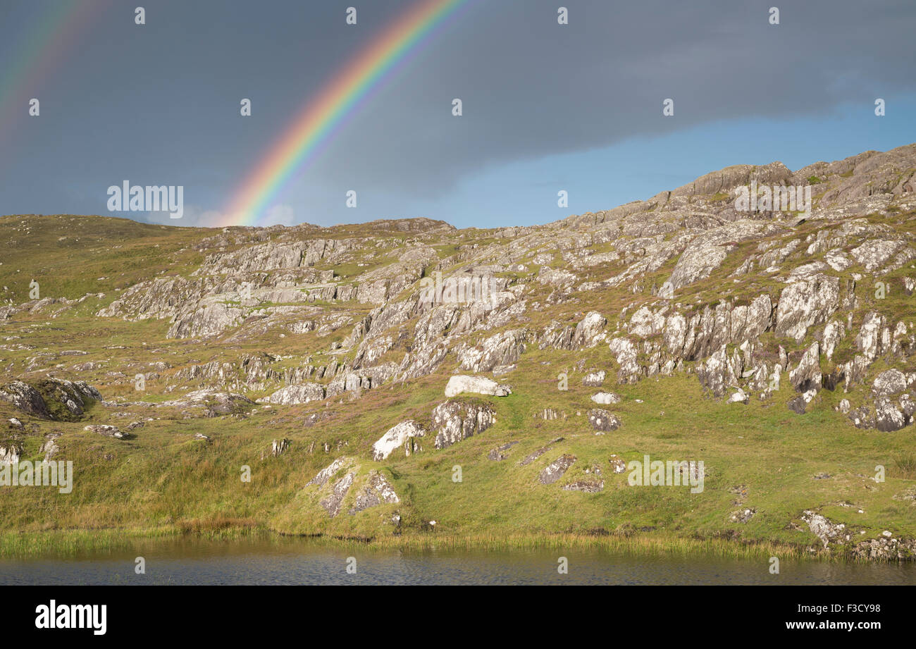 Rainbow during rain shower on the Beara Way walking path in Garinish, Beara Peninsula, County Cork, Ireland Stock Photo