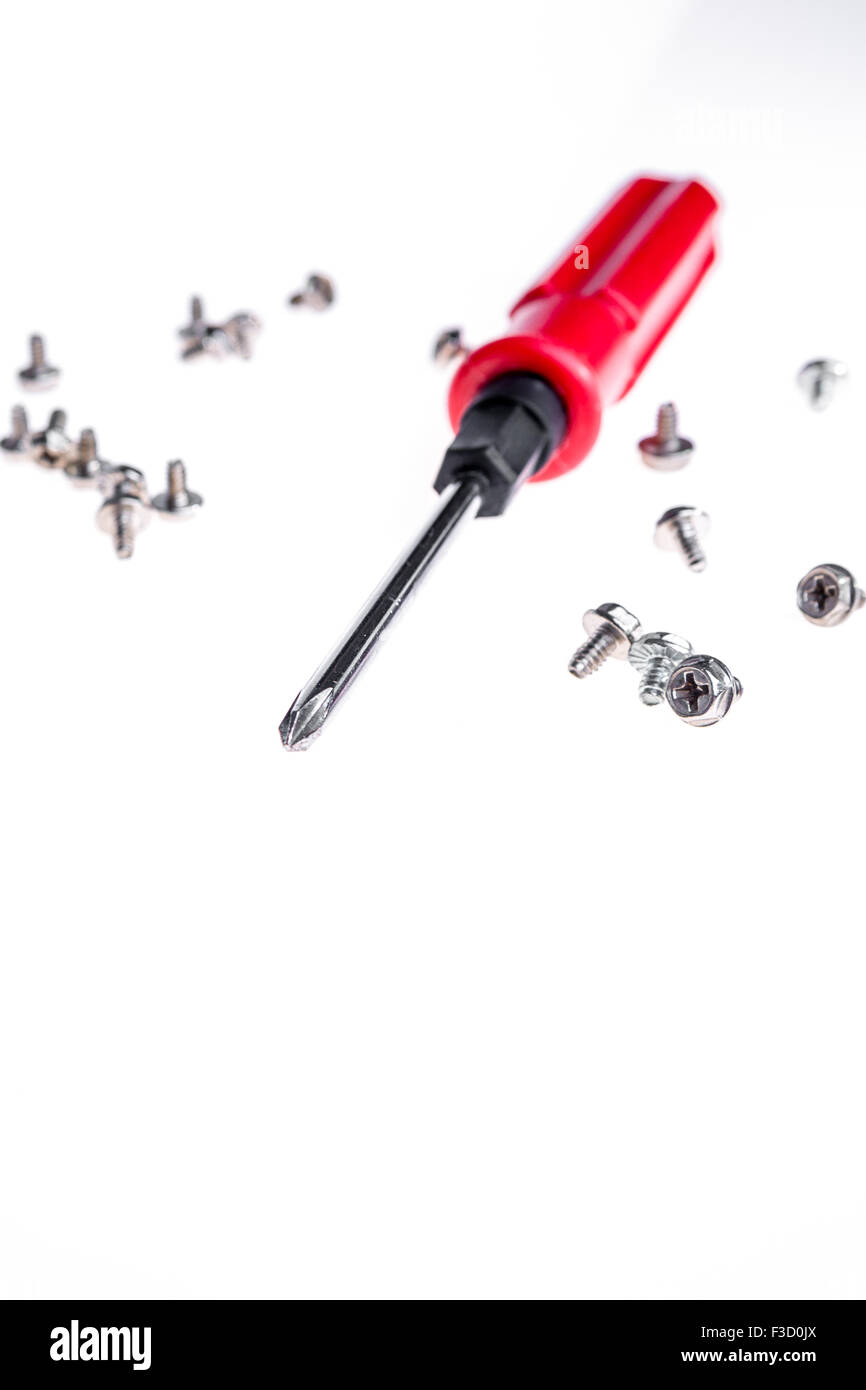 an isolated short of yellow handle screwdriver  and screws Stock Photo