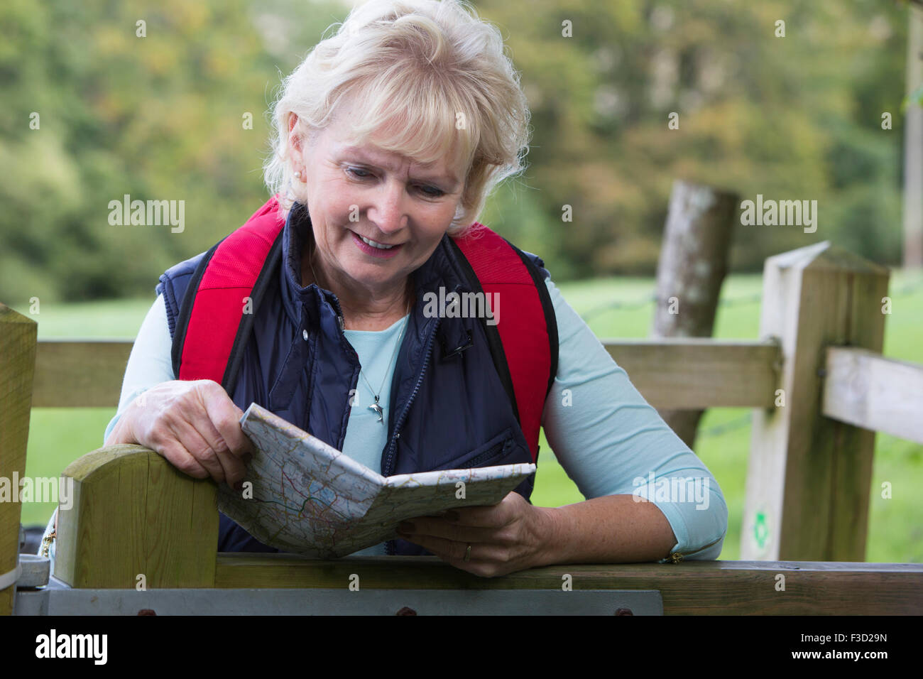 Active Senior Woman On Walk In Countryside Stock Photo