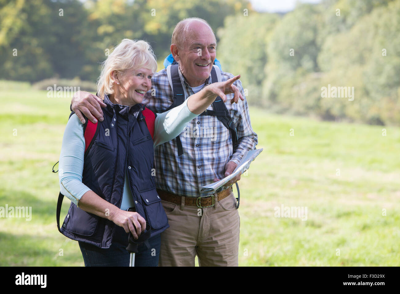 Active Senior Couple On Walk In Countryside Together Stock Photo
