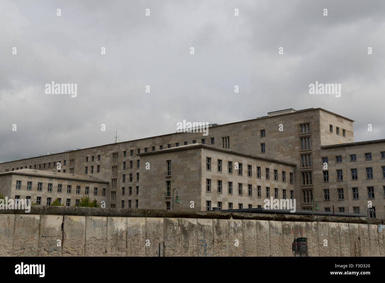 Nazi building of the German Third Reich in Berlin, with the Berlin wall in front. Stock Photo