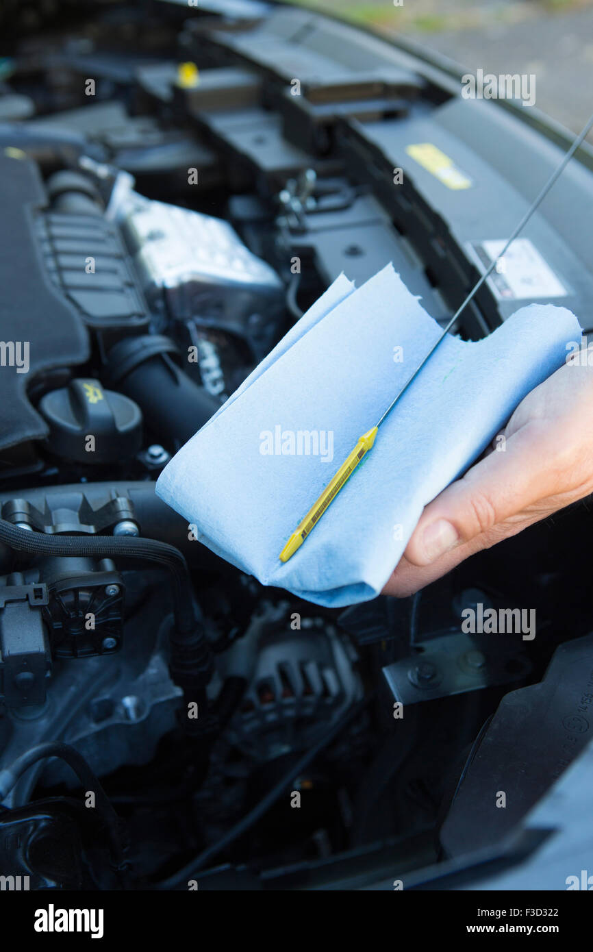 Close-Up Of Man Checking Car Engine Oil Level On Dipstick Stock Photo
