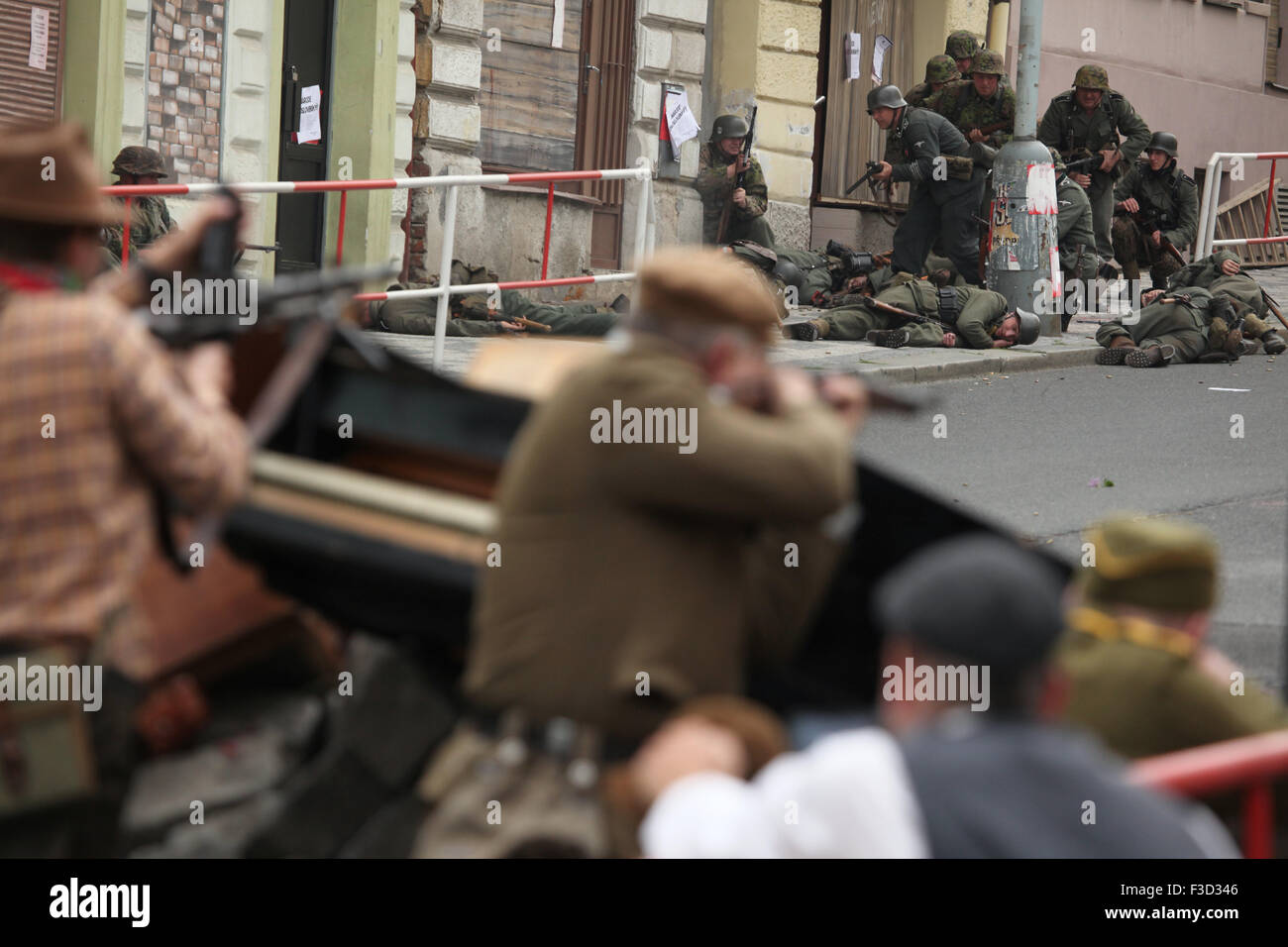 Reenactors dressed as the Czech insurgents defend a barricade against the German Nazi troops during the reenactment of the 1945 Prague uprising in Prague, Czech Republic, on May 9, 2015. Stock Photo