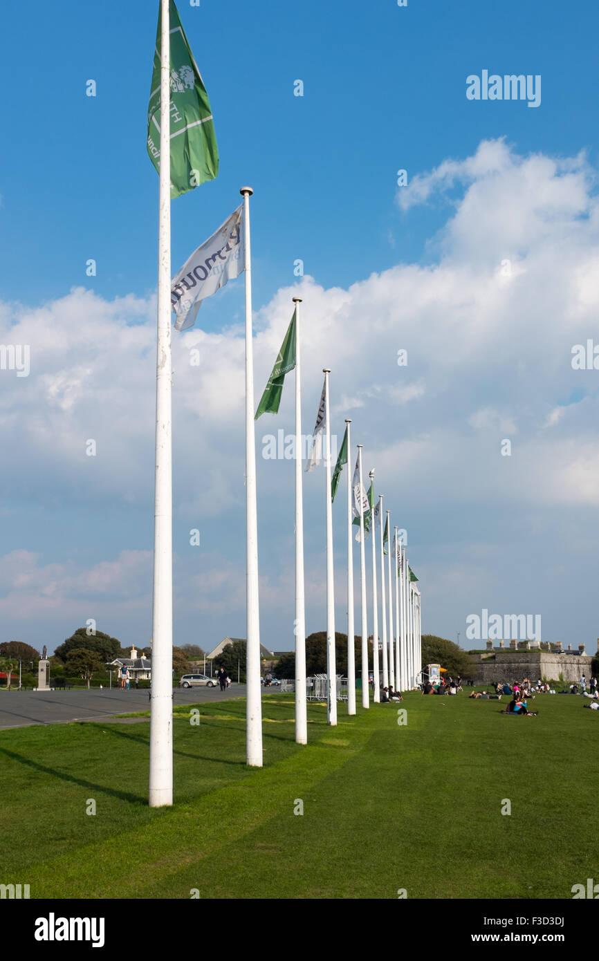 A long row of flag poles along Hoe Promenade on Plymouth Hoe Stock Photo