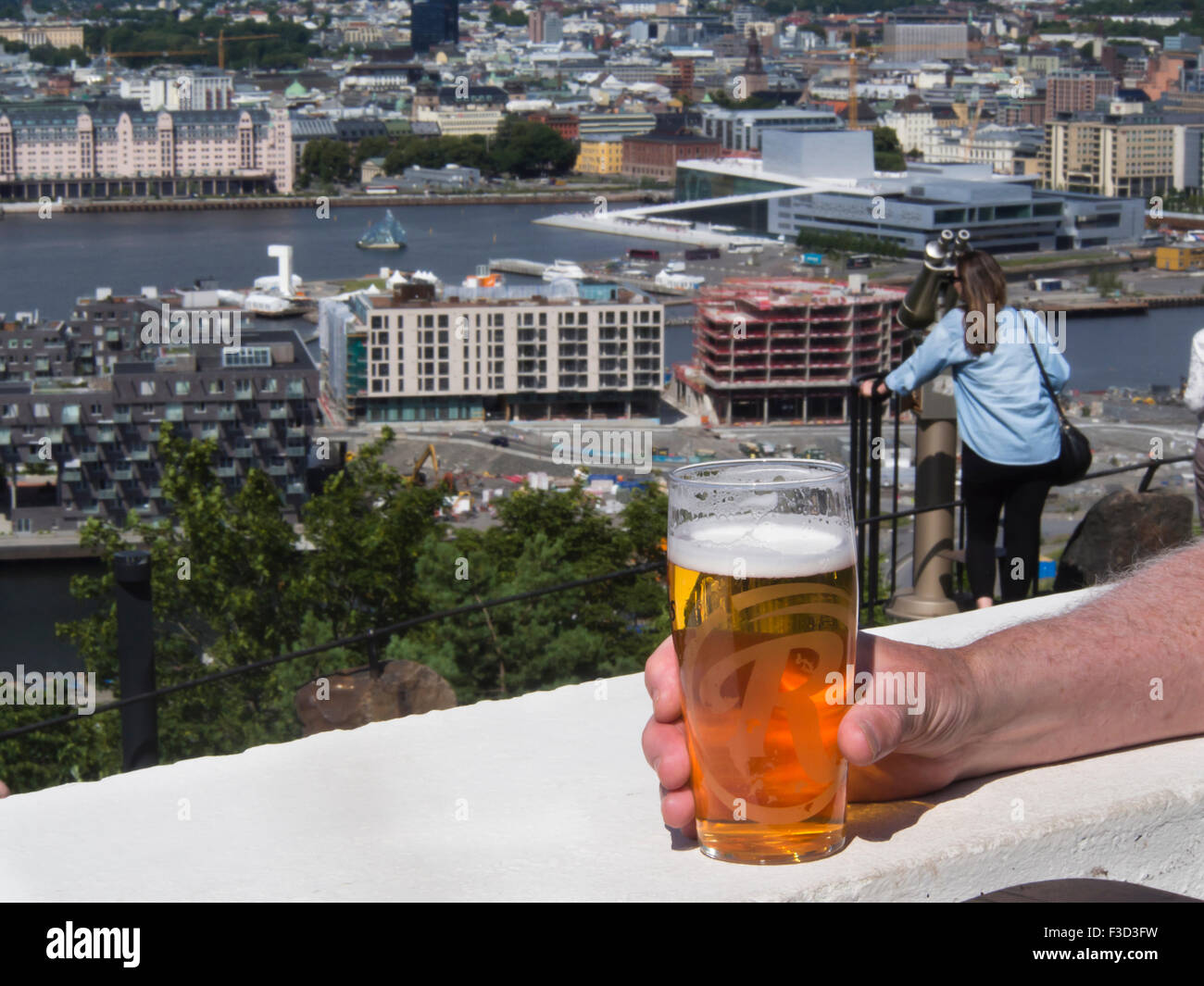 From the Ekeberg  restaurant you  have a superb view of central Oslo Norway, the Opera house and the fjord while enjoying a beer Stock Photo