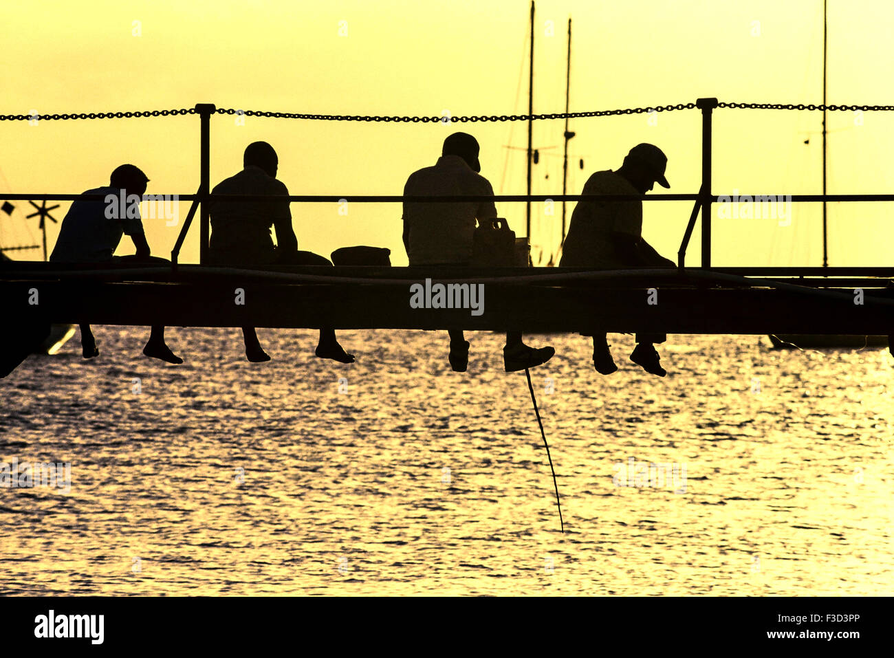Locals fishing from a wooden pier. Barbados. Caribbean. West Indies Stock Photo