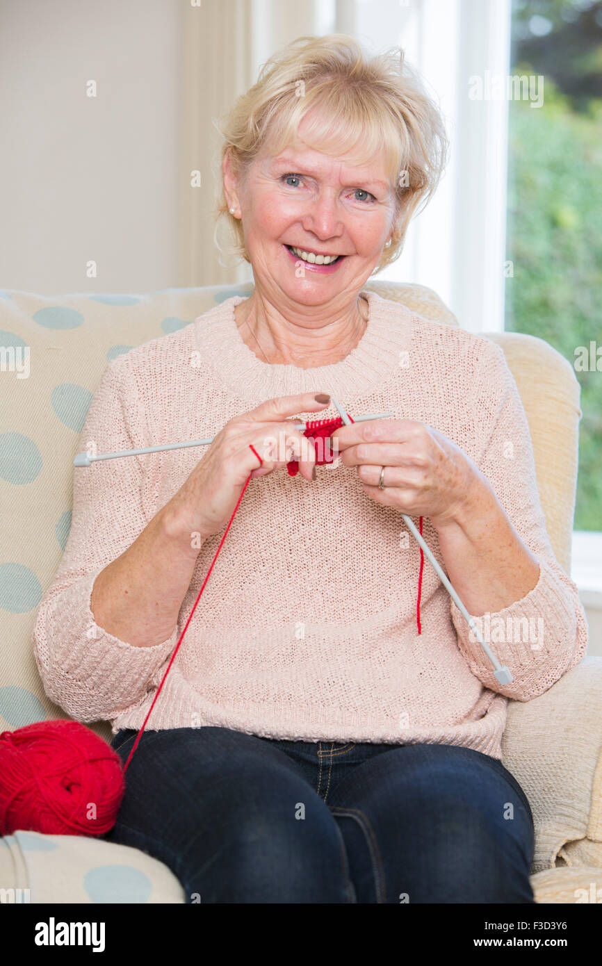 Portrait Of Senior Woman Sitting In Chair Knitting Stock Photo - Alamy