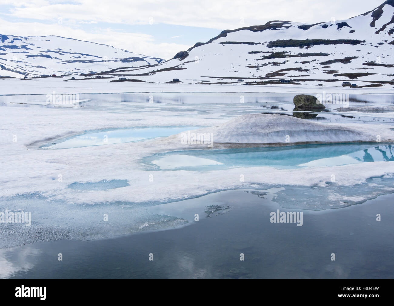 Norwegian mountain panorama, Finse lake, Hardangervidda Norway, some ice and snow still in summer,  reflections Stock Photo