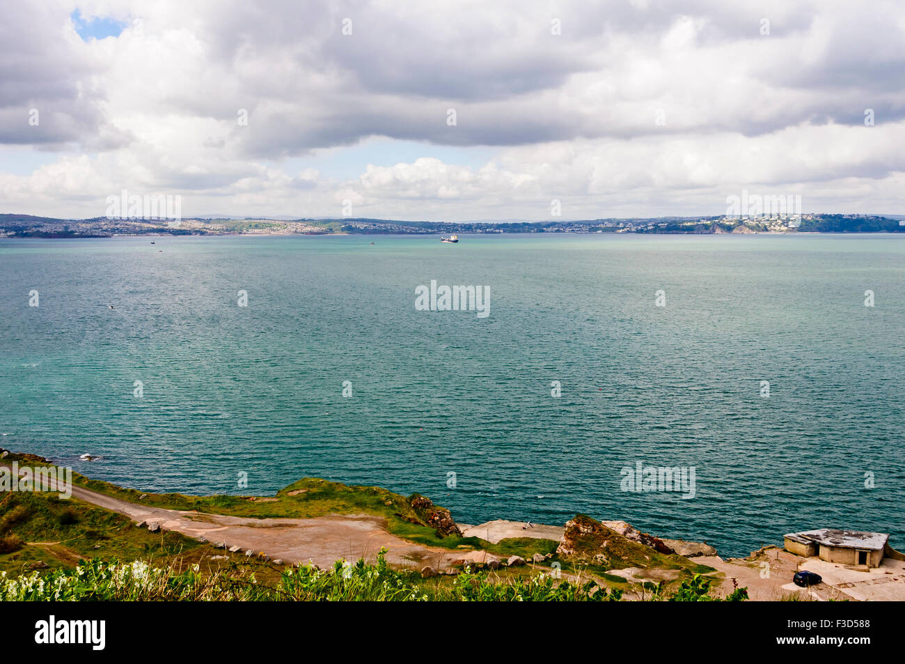 Looking across Tor Bay from the coastal headland of Berry Head at the southern end of Torbay towards the east cost of Devon Stock Photo