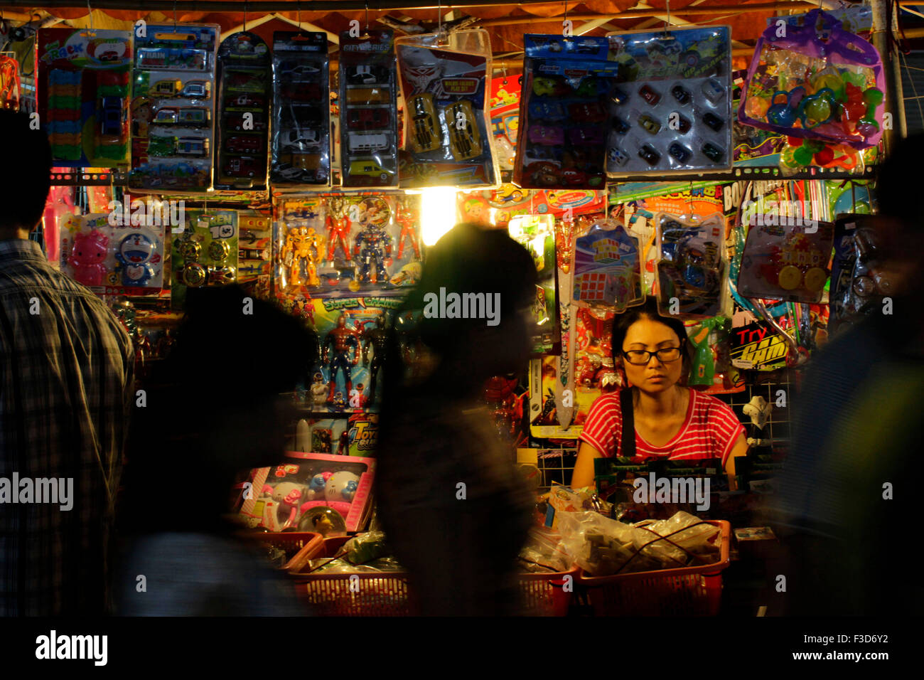 A woman sells toys on Hanoi's Weekend Night Market, Vietnam Stock Photo