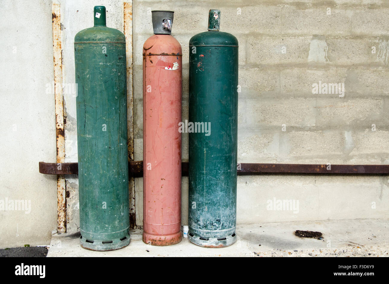 Colored big gas bottles in the street, green, red Stock Photo