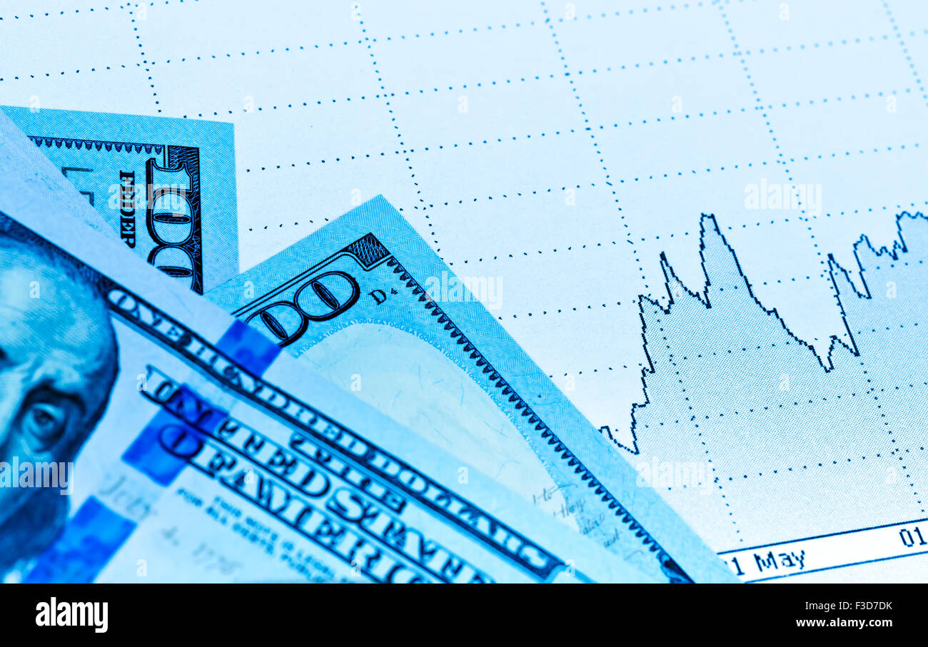 Currency market concept paper chart graph. Toned in blue Stock Photo