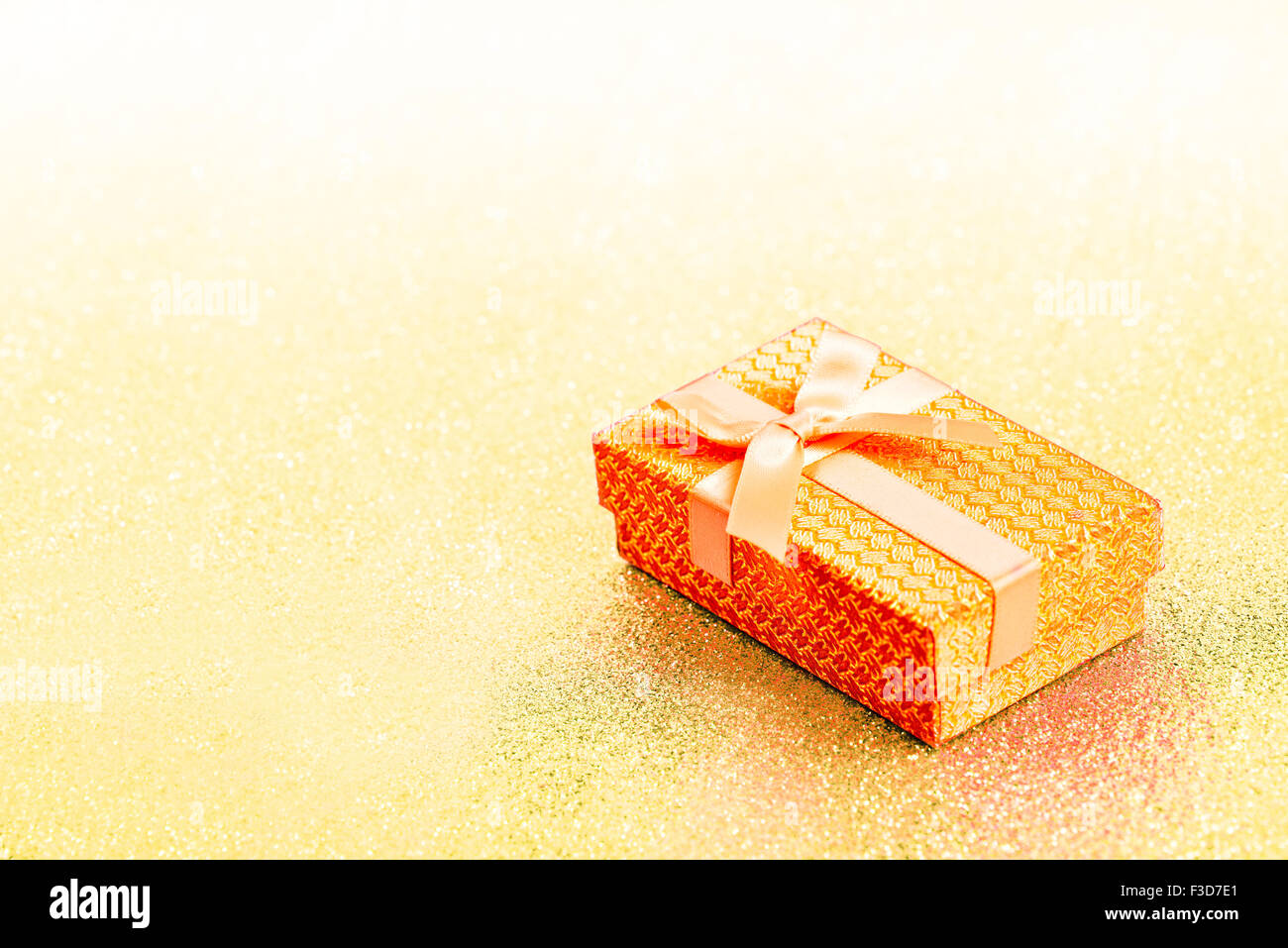 Abstract yellow golden christmas background with gift box Stock Photo