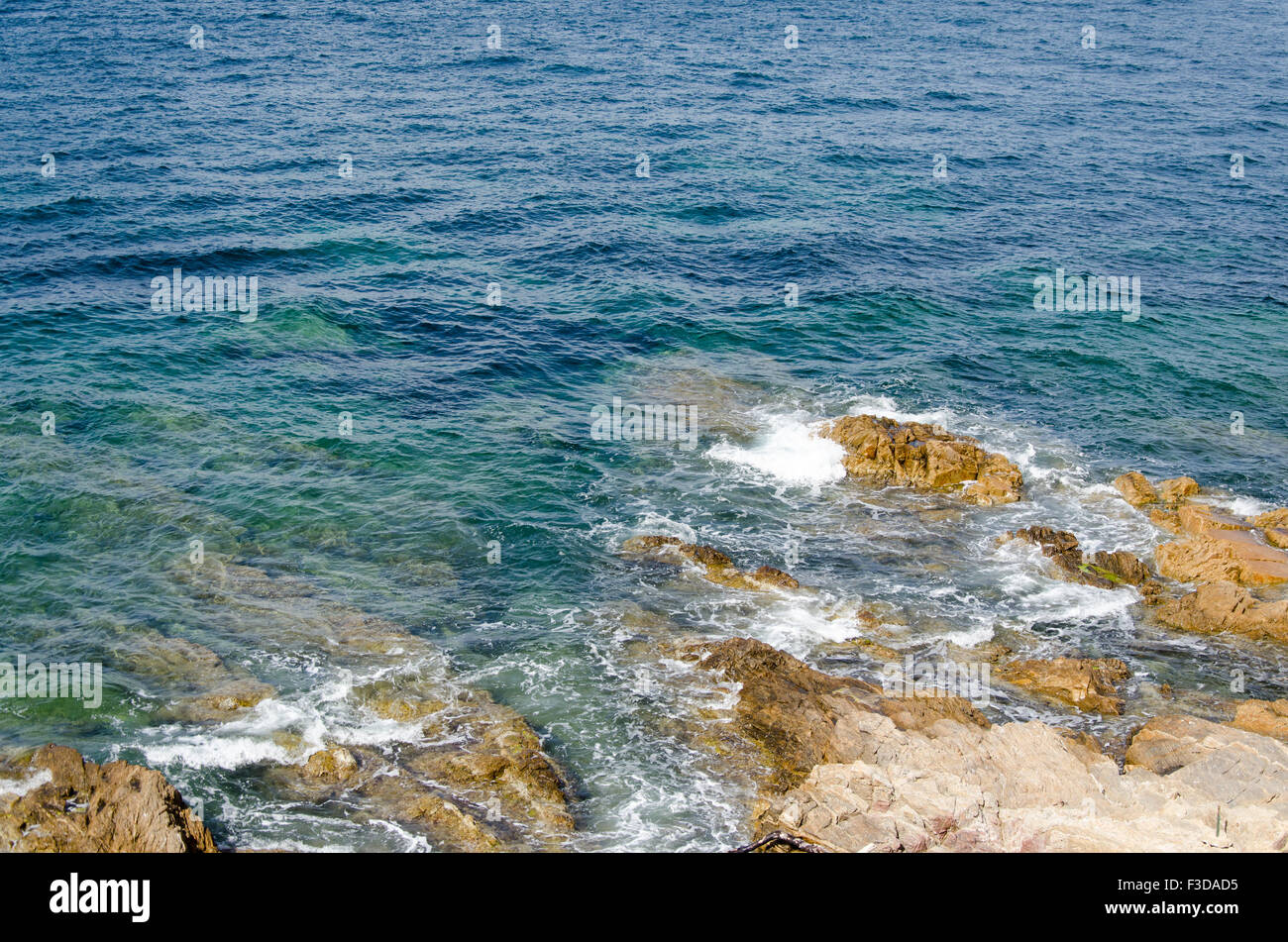 Blue, green, turquoise sea with rocks and waves Stock Photo - Alamy