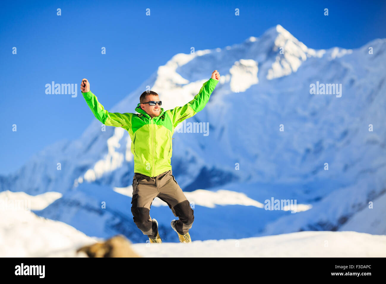Man hiker or climber happy ecstatic achievement in winter mountains, inspiration and motivation accomplish business success. Stock Photo