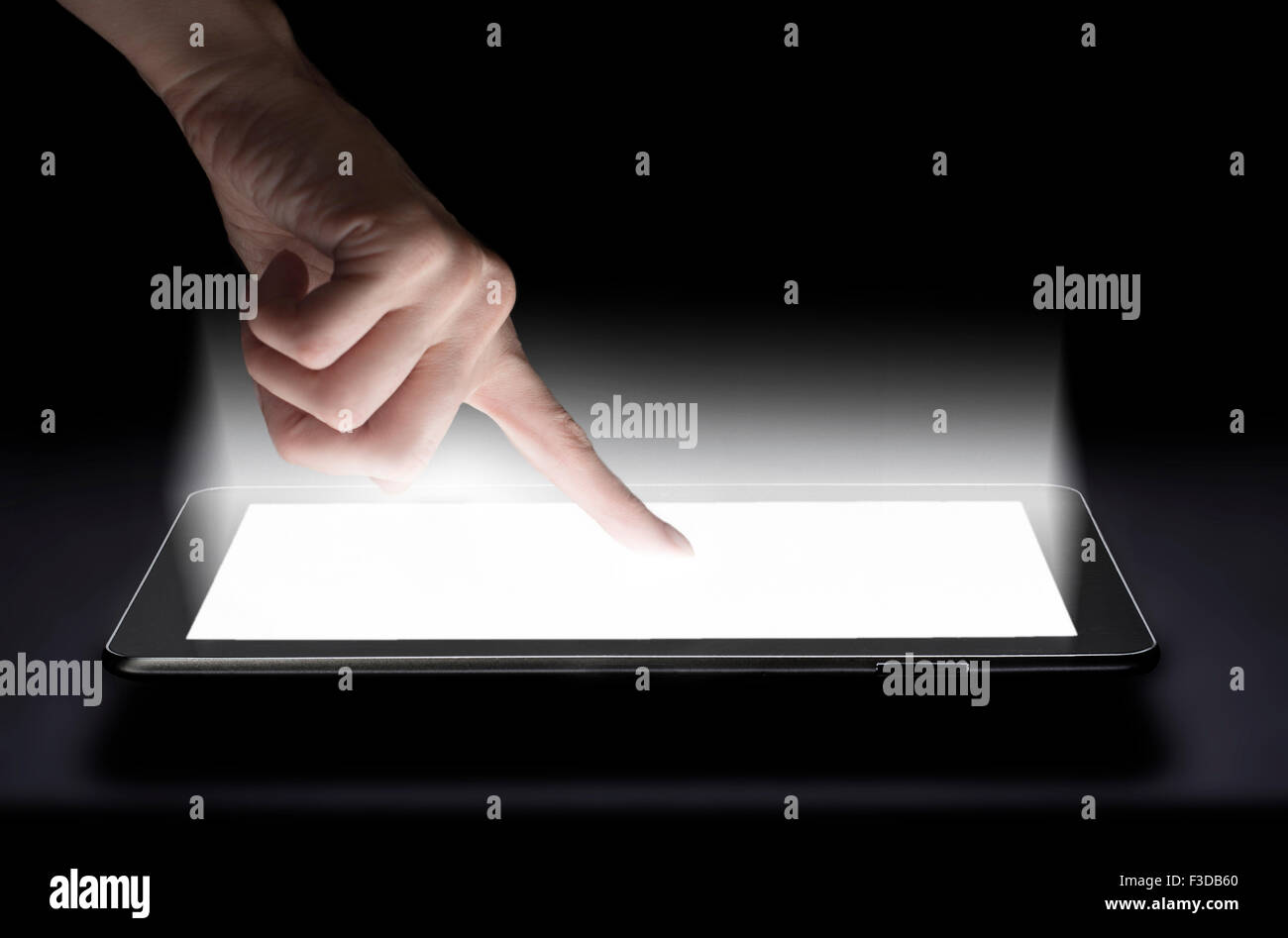 Woman touching digital tablet in studio Stock Photo