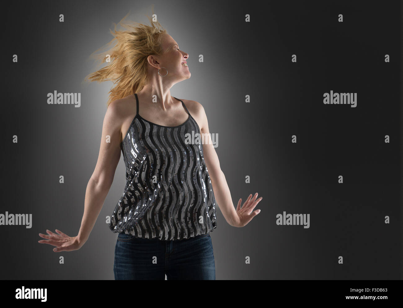 Happy woman dancing in studio Stock Photo