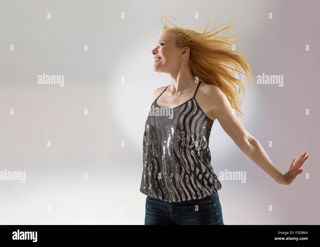 Happy woman dancing in studio Stock Photo