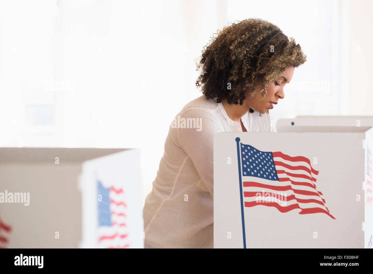 Young woman preparing voting booth Stock Photo