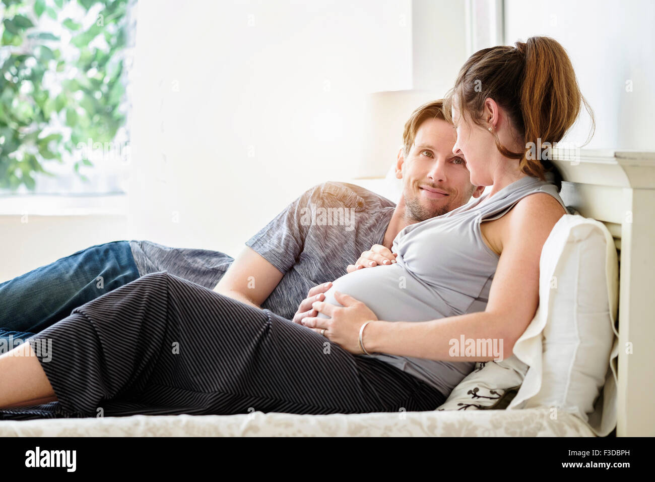 Couple lying in bed Stock Photo