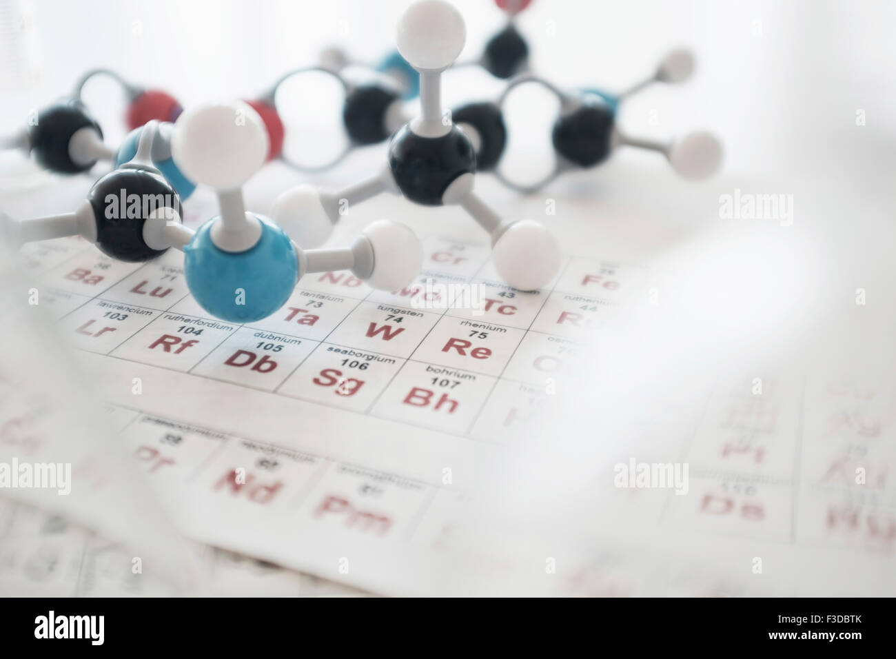 Molecular structure and periodic table on desk Stock Photo - Alamy