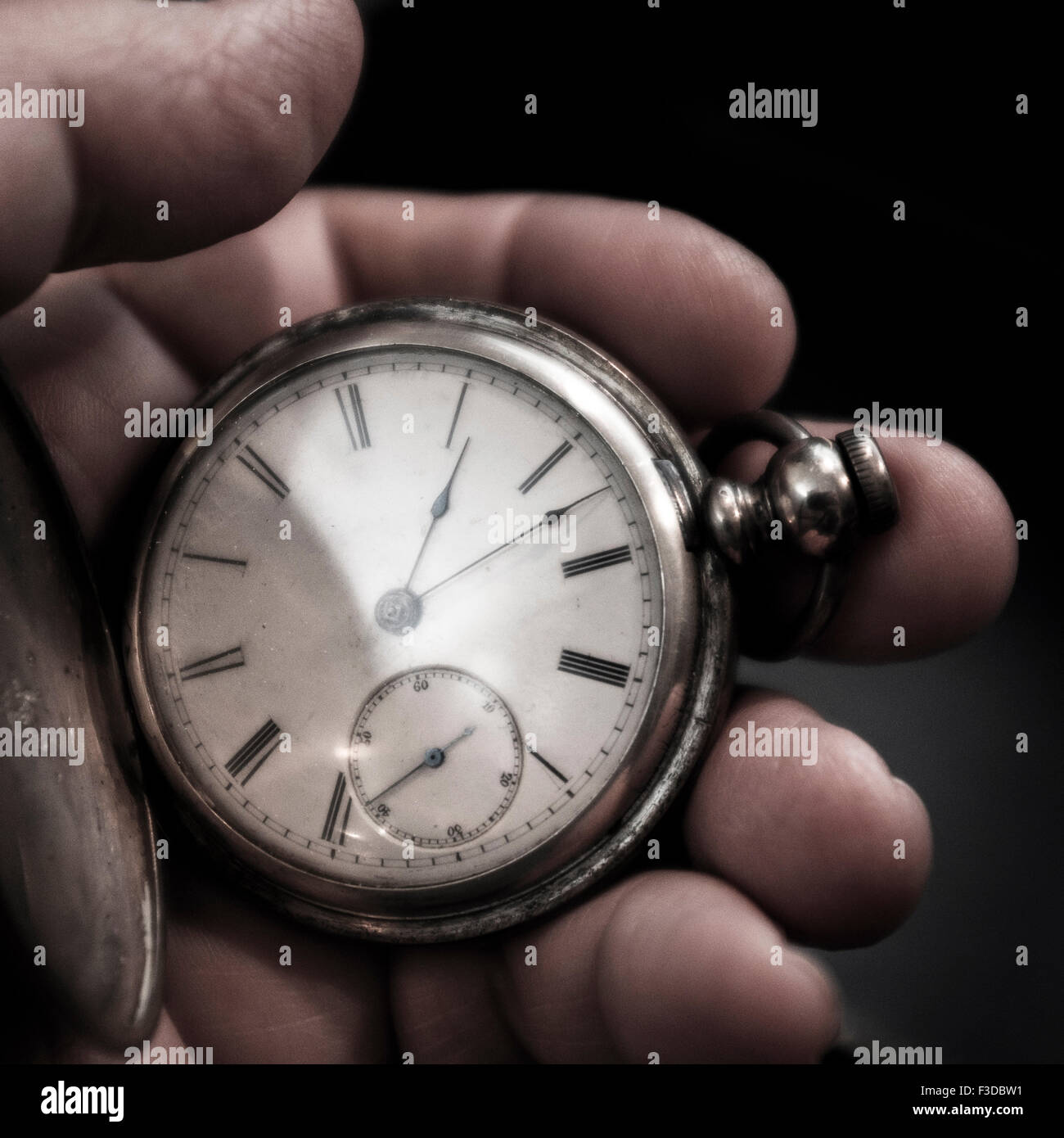 Pocket watch in man's hand Stock Photo
