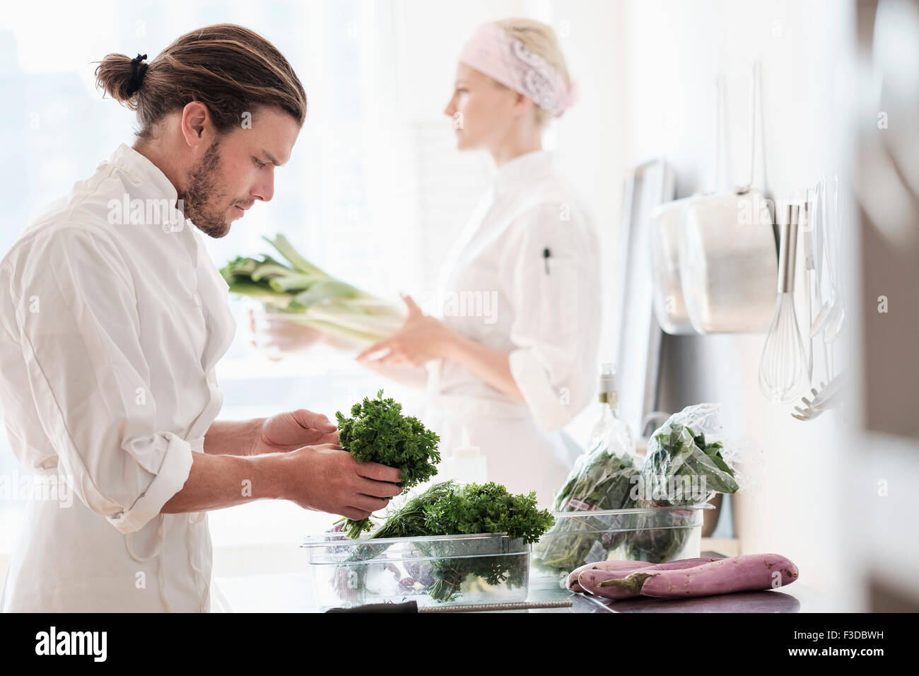 Chefs working in kitchen Stock Photo