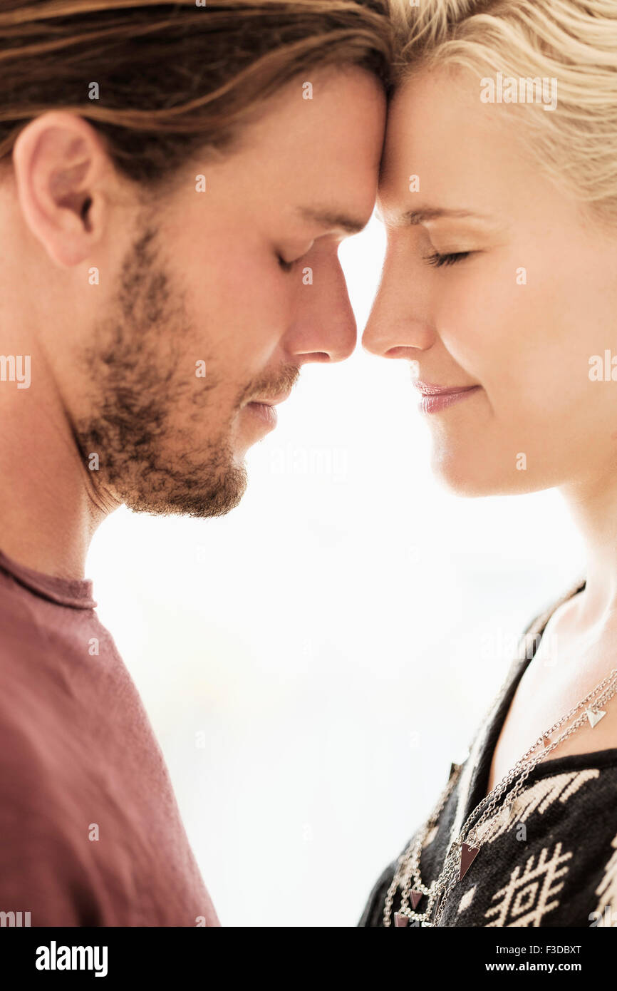 Couple rubbing noses on white background Stock Photo