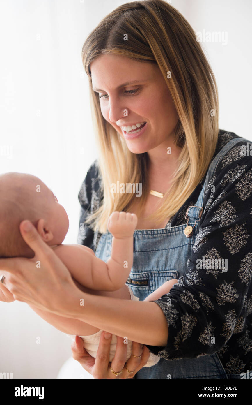 Mother holding baby girl (2-5 months) in her arms Stock Photo
