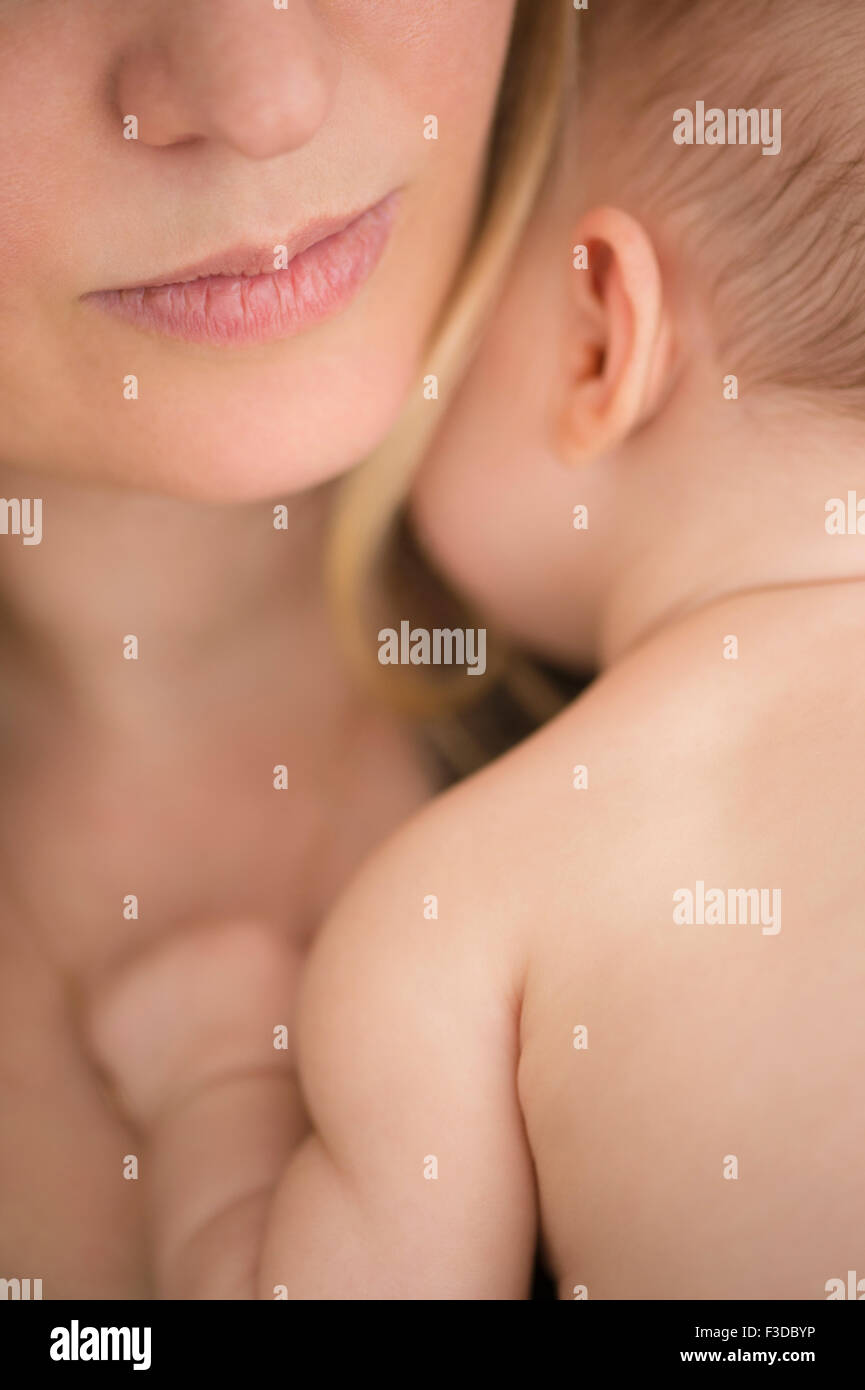 Mother consoling baby girl (2-5 months) Stock Photo