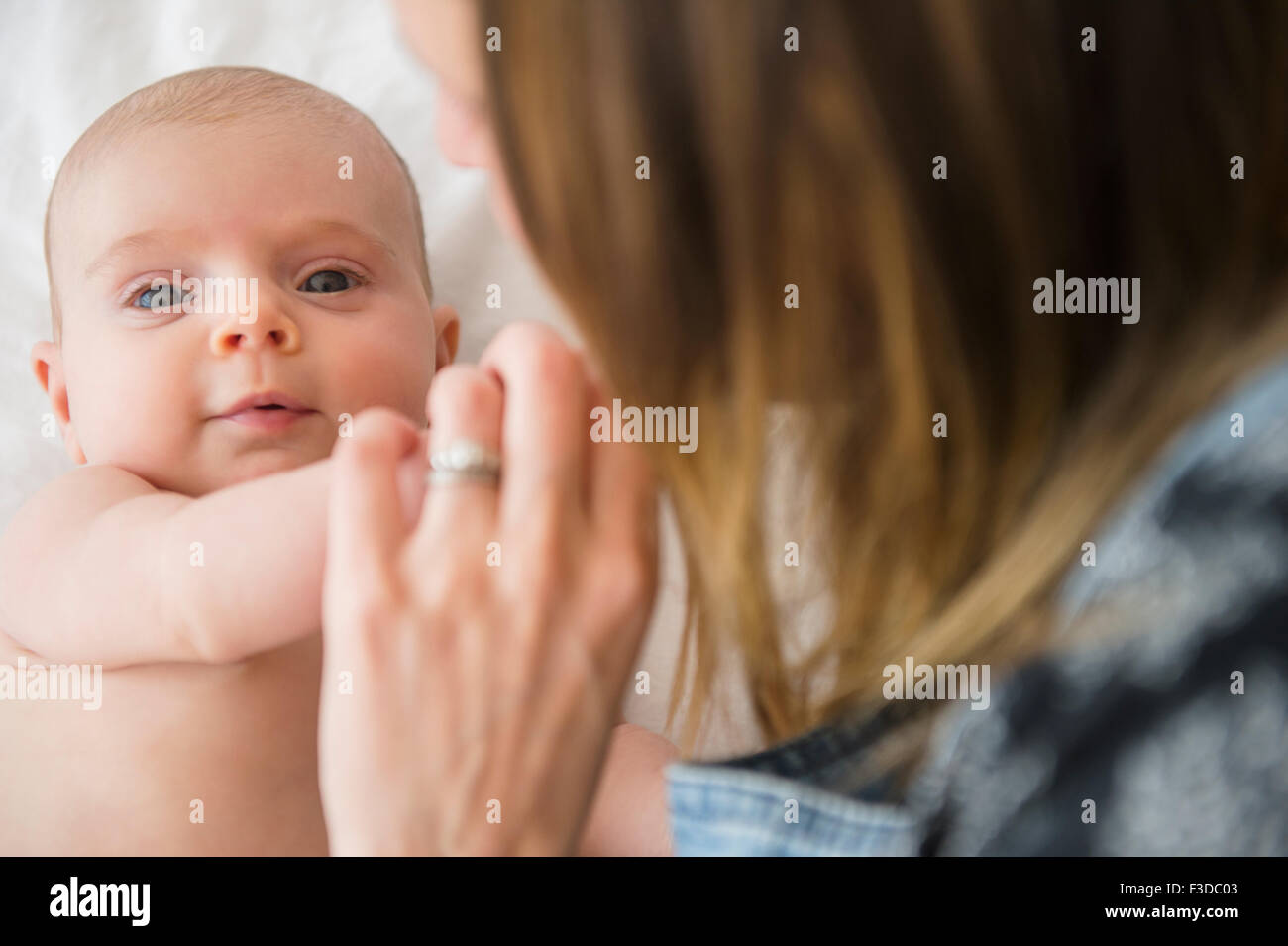 Mother consoling baby girl (2-5 months) Stock Photo