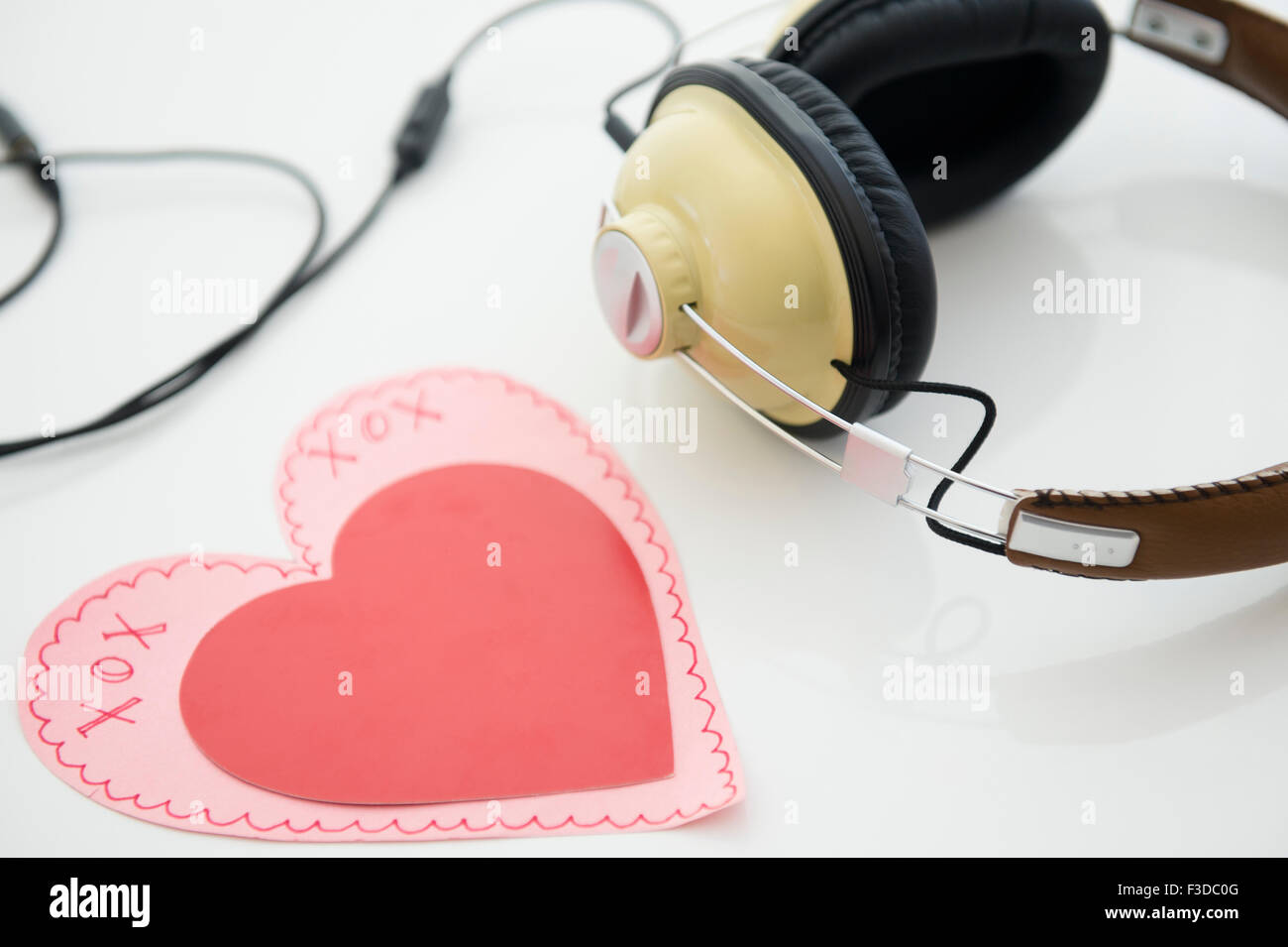 Studio shot of heart shaped paper cutout and headphones Stock Photo