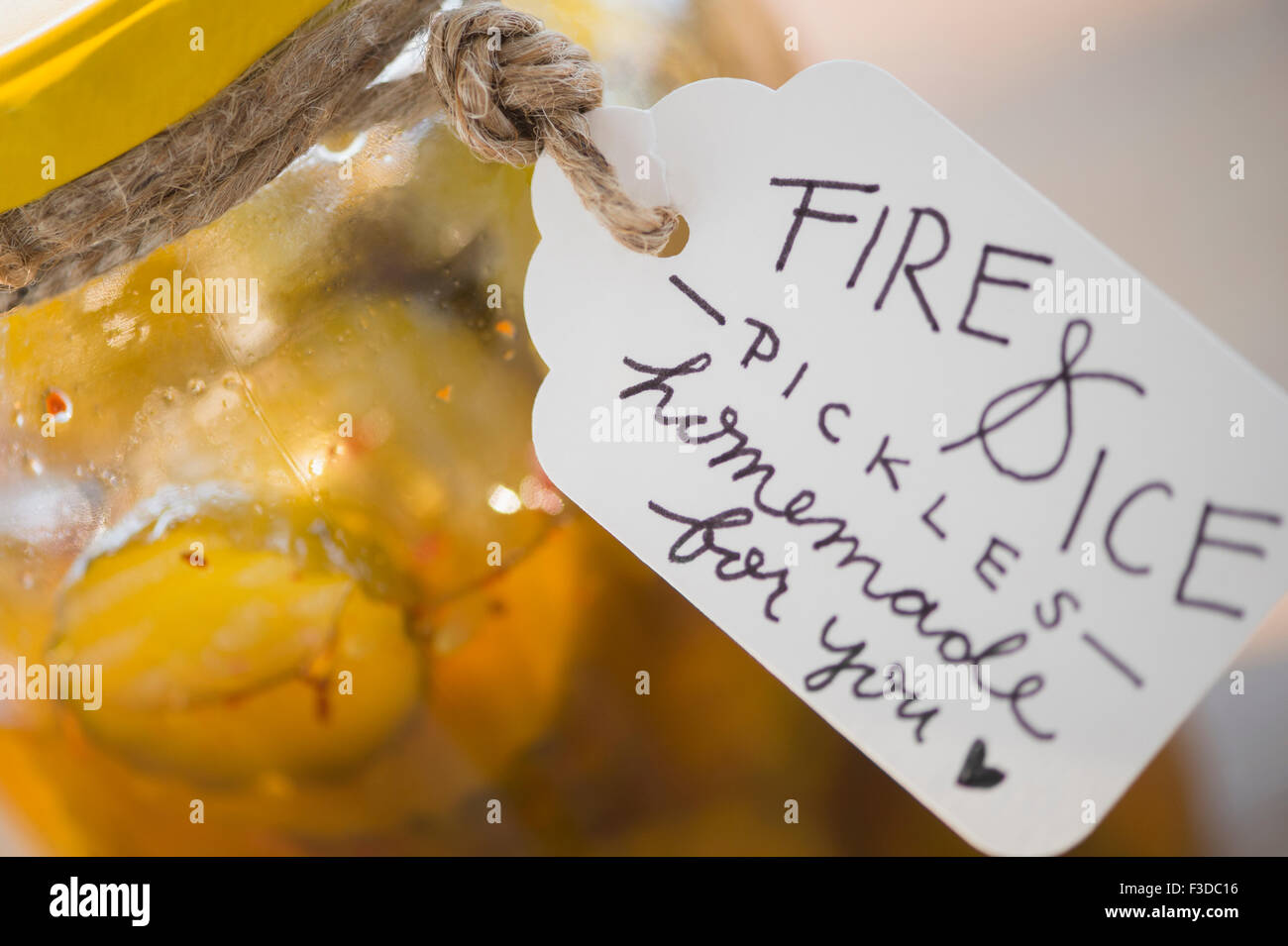 Jar with spicy pickles and hand written tag Stock Photo
