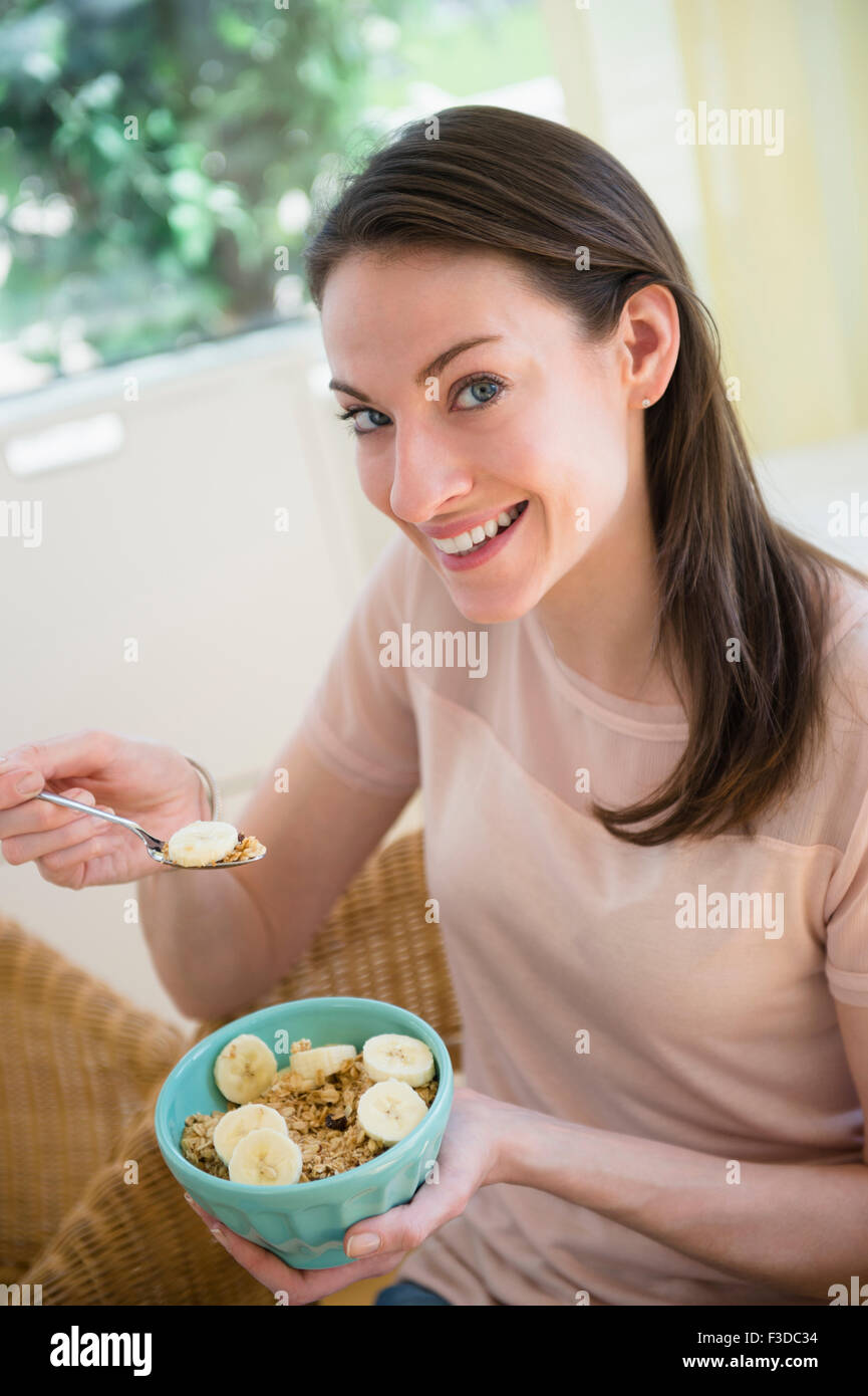 Woman at home eating healthy breakfast Stock Photo