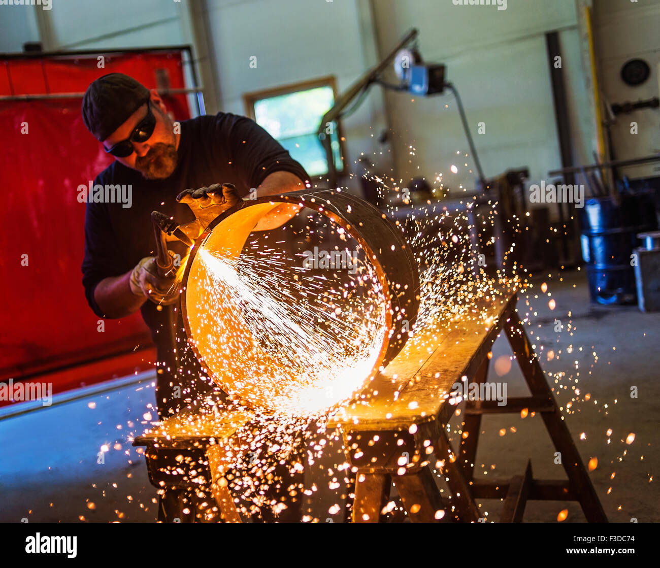 Welder working in metal workshop Stock Photo