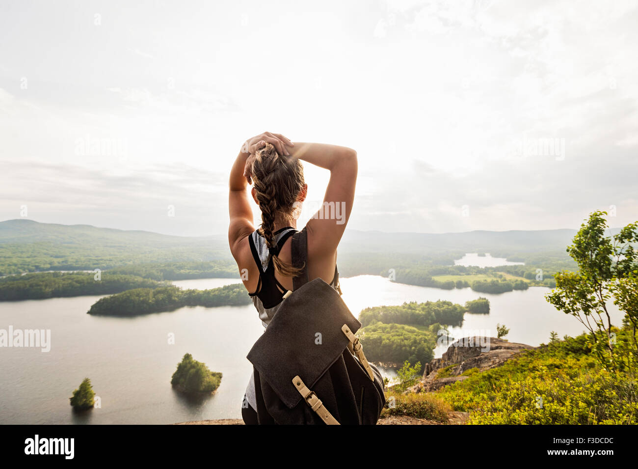 Rear view of young woman with arms up hi-res stock photography and ...