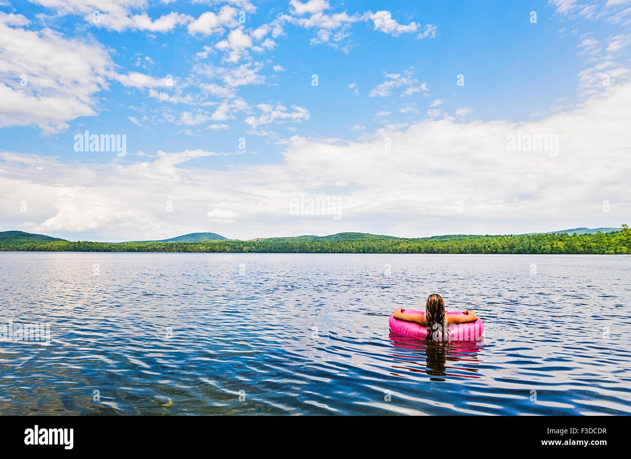Young woman relaxing on lake in pool raft Stock Photo - Alamy